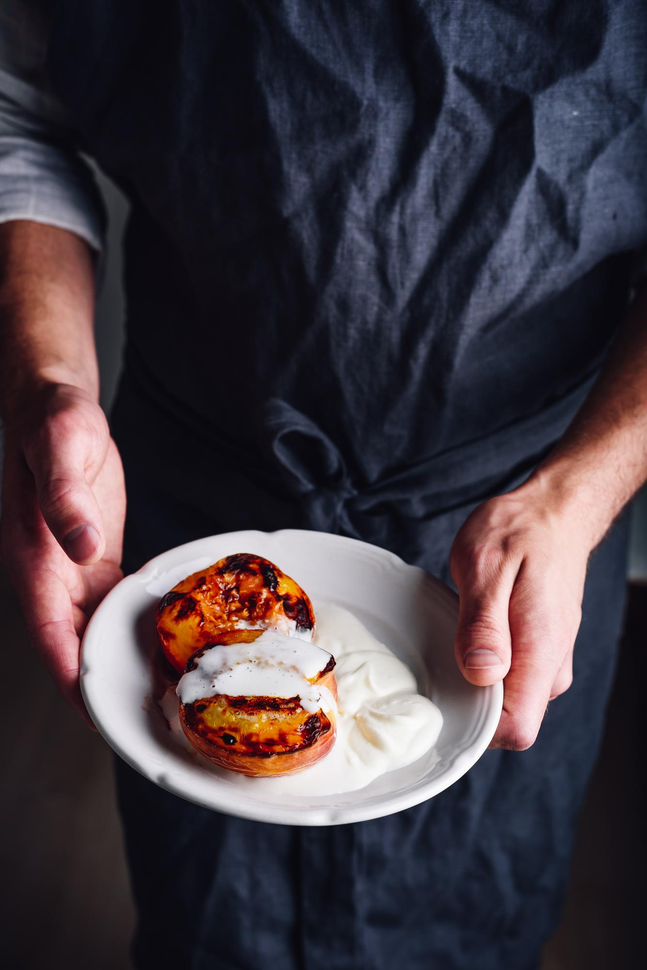 Instructor plating a dish in a calm studio